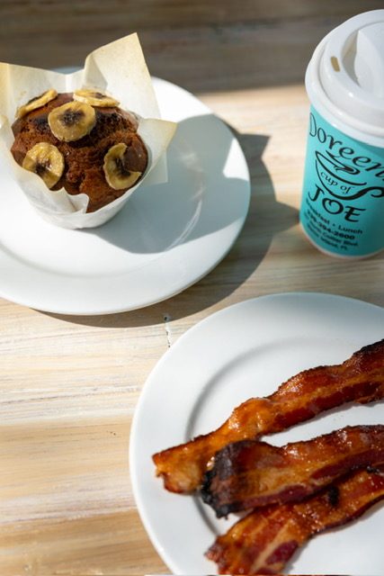 Banana muffin, bacon and a Doreen's Cup of Joe coffee cup