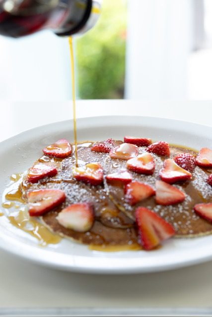 Strawberry pancakes with maple syrup